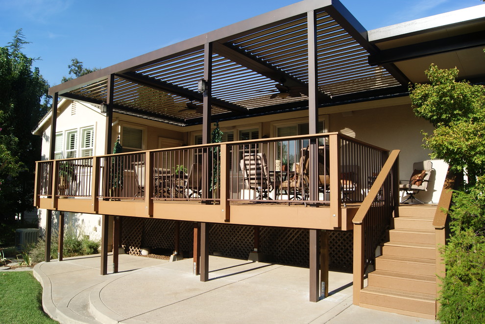Mid-sized traditional backyard deck in Sacramento with a pergola.