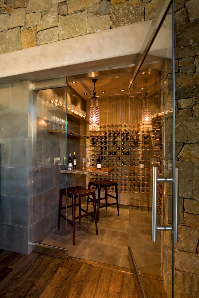 Design ideas for a mediterranean wine cellar in Phoenix with storage racks.