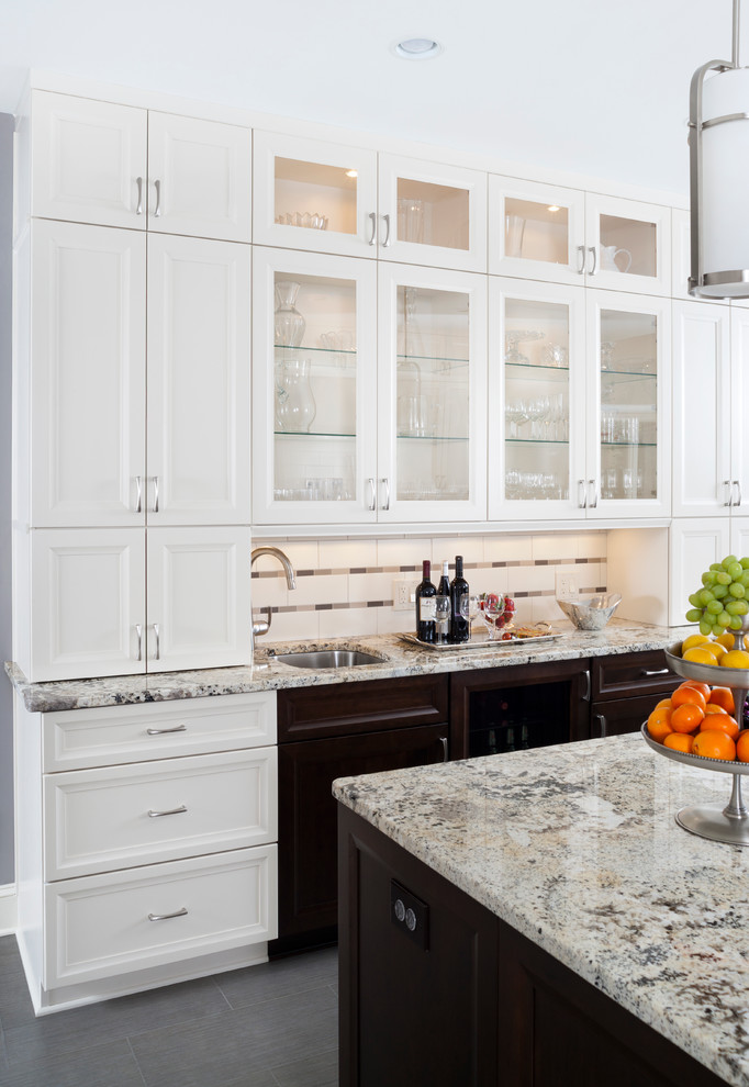 Inspiration for a large transitional u-shaped ceramic tile enclosed kitchen remodel in Baltimore with a single-bowl sink, recessed-panel cabinets, white cabinets, granite countertops, white backsplash, subway tile backsplash, stainless steel appliances and an island