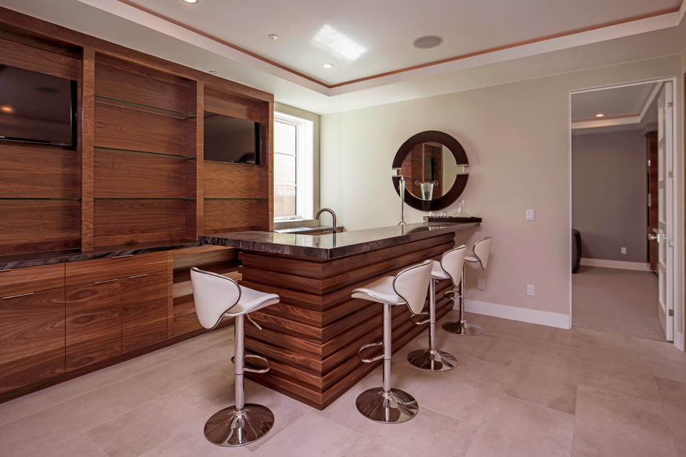This is an example of a contemporary galley seated home bar in San Francisco with an undermount sink, flat-panel cabinets, dark wood cabinets, granite benchtops and porcelain floors.