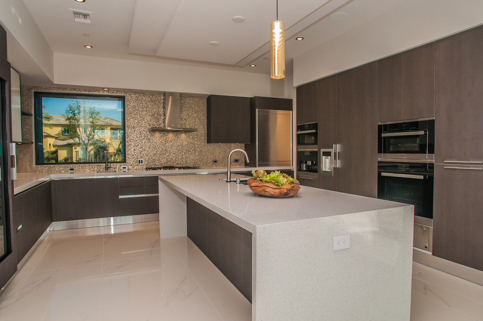 Large contemporary u-shaped eat-in kitchen in Los Angeles with a double-bowl sink, flat-panel cabinets, dark wood cabinets, quartzite benchtops, multi-coloured splashback, metal splashback, stainless steel appliances, porcelain floors and with island.