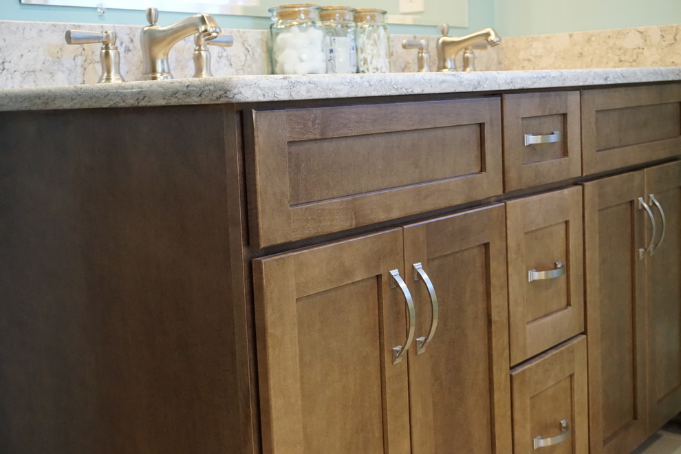 Mid-sized transitional master white tile and subway tile porcelain tile and beige floor home design photo in Providence with recessed-panel cabinets, brown cabinets, blue walls, an undermount sink, quartz countertops and multicolored countertops