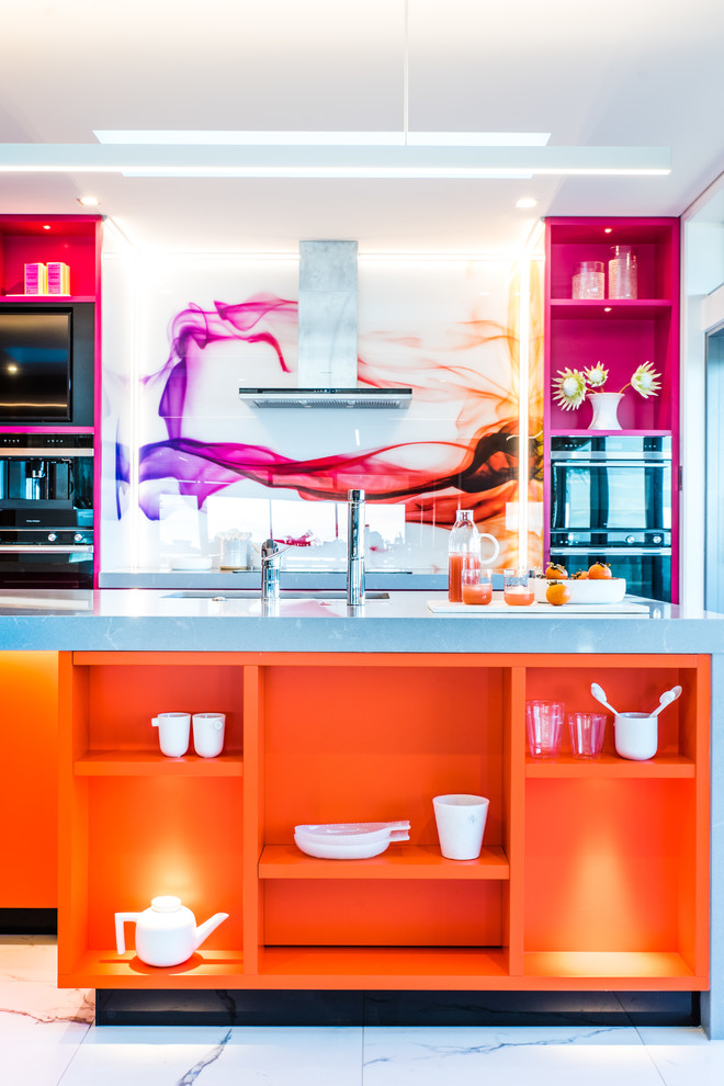 Photo of a large contemporary galley kitchen pantry in Napier-Hastings with an undermount sink, orange cabinets, quartzite benchtops, multi-coloured splashback, glass sheet splashback, stainless steel appliances, ceramic floors, with island, white floor and grey benchtop.