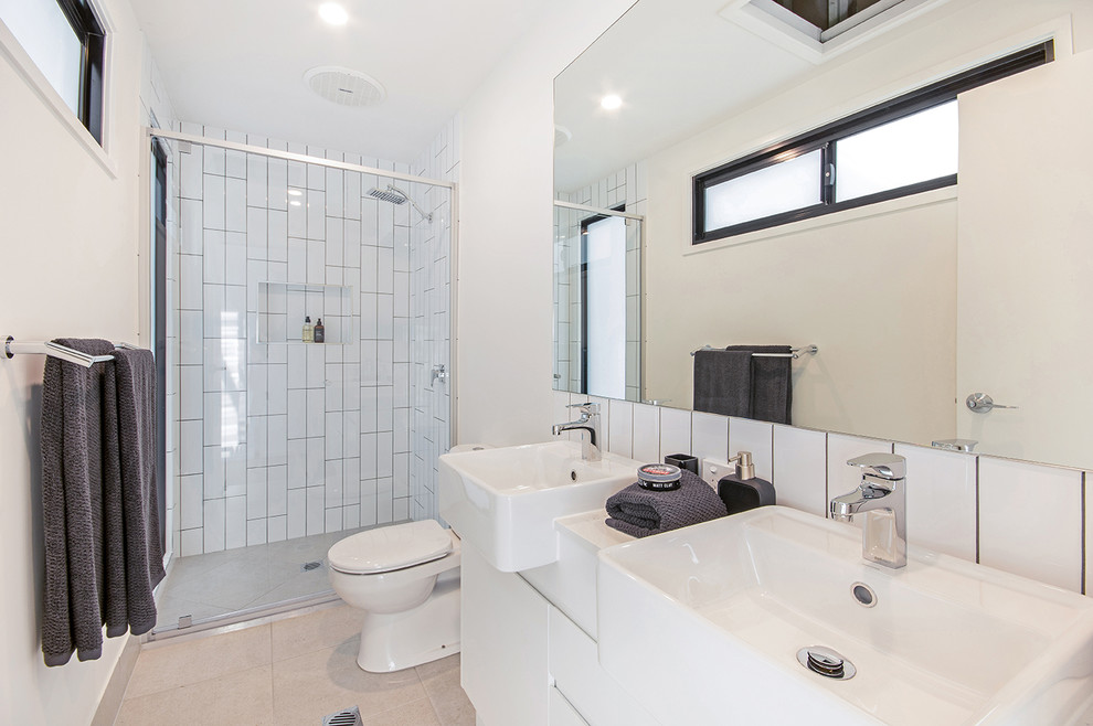Photo of an industrial bathroom in Sunshine Coast with white cabinets, an open shower, a one-piece toilet, white tile, ceramic tile, white walls, ceramic floors, engineered quartz benchtops, beige floor and an open shower.
