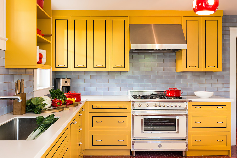 Inspiration for a contemporary l-shaped kitchen in Boston with an undermount sink, yellow cabinets, blue splashback, flat-panel cabinets, stainless steel appliances and with island.