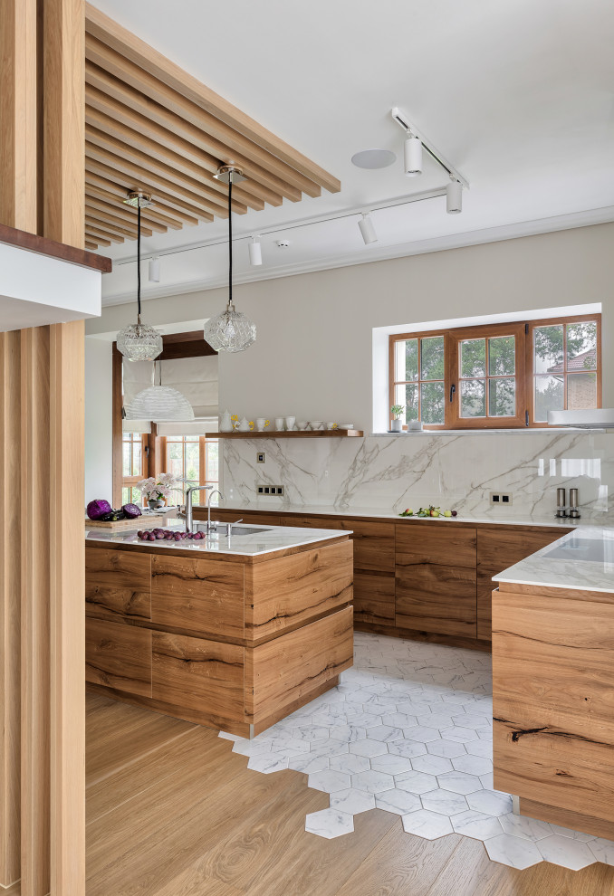 Large contemporary l-shaped open plan kitchen in Saint Petersburg with a submerged sink, all styles of cabinet, light wood cabinets, marble worktops, white splashback, marble splashback, white appliances, porcelain flooring, an island, white floors, white worktops, a wood ceiling and feature lighting.