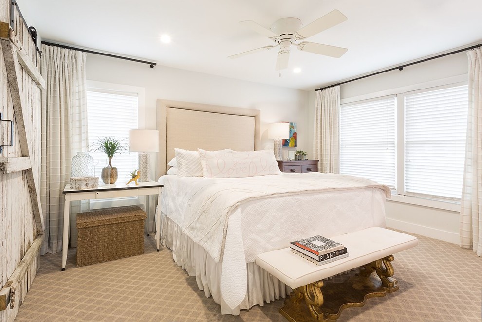 Inspiration for a mid-sized beach style master bedroom in Austin with white walls, carpet and beige floor.