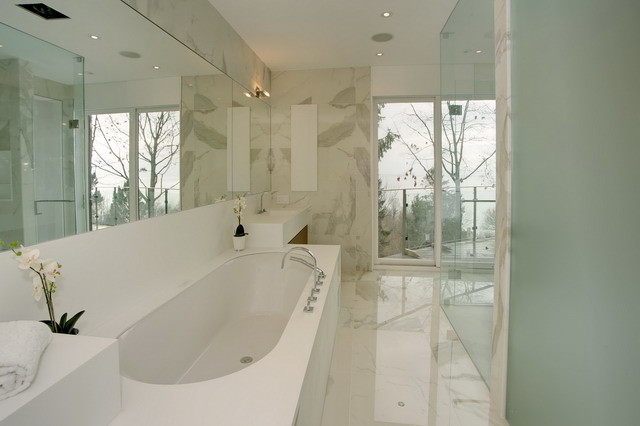 Large modern master bathroom in Toronto with flat-panel cabinets, medium wood cabinets, an undermount tub, a corner shower, a two-piece toilet, white tile, beige walls, marble floors, a trough sink and solid surface benchtops.