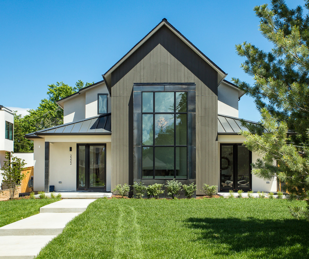 This is an example of a large country two-storey house exterior in Denver with a metal roof.