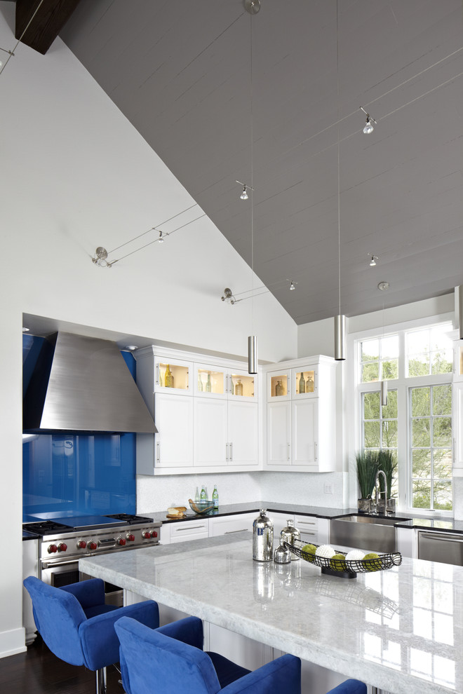 Contemporary kitchen in Austin with stainless steel appliances, quartzite benchtops, blue splashback and glass sheet splashback.