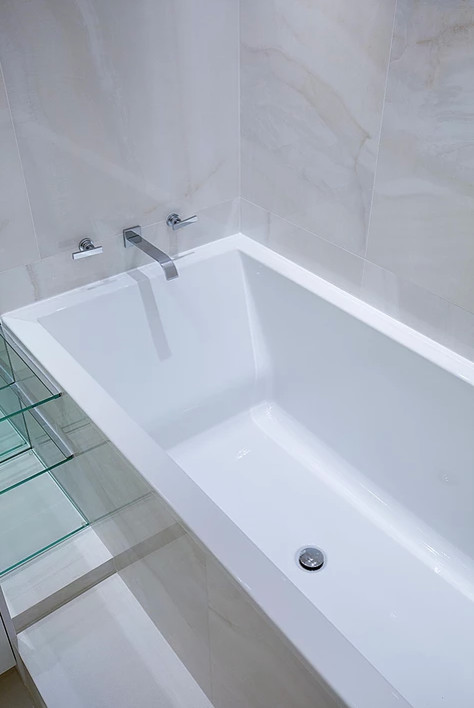 Example of a mid-sized transitional master white floor freestanding bathtub design in New York with flat-panel cabinets, white cabinets, white walls, an undermount sink and a hinged shower door