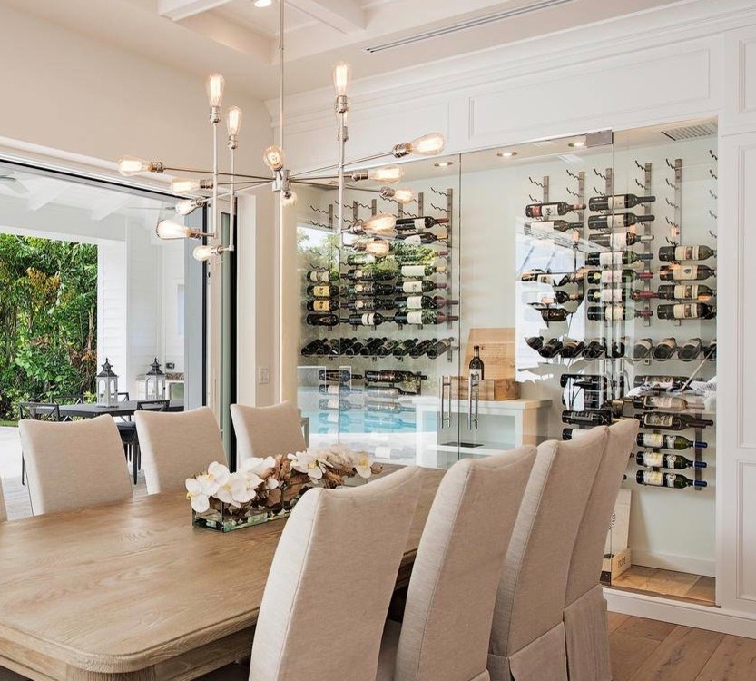 Mid-sized contemporary wine cellar in Miami with cork floors, storage racks and beige floor.