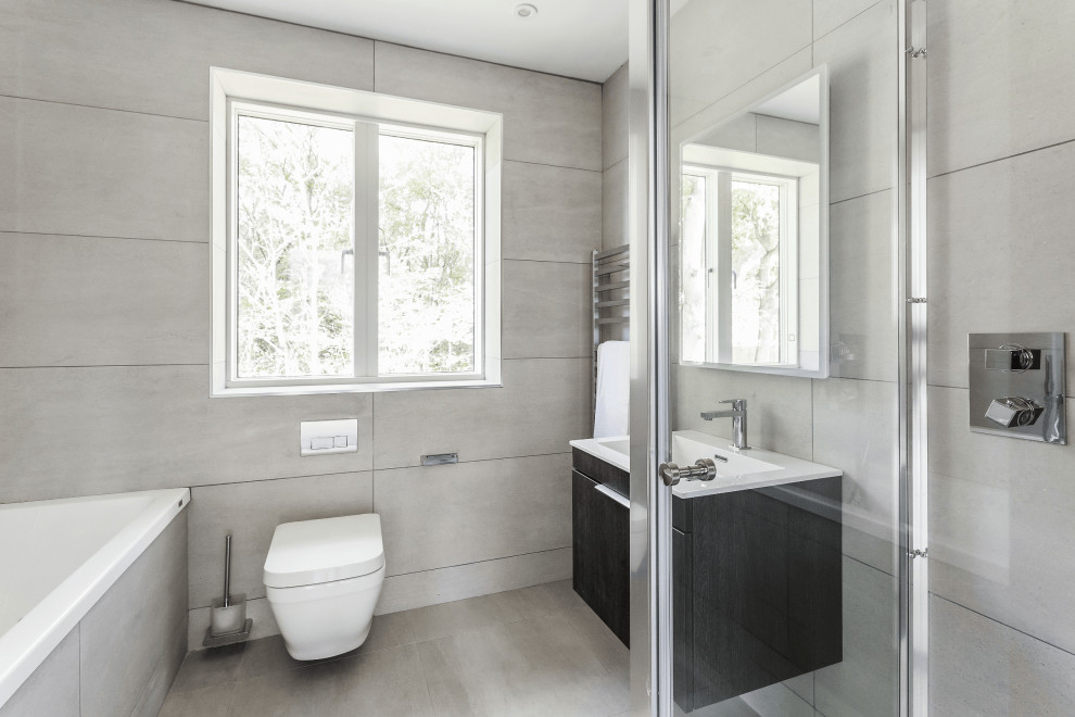 Inspiration for a contemporary porcelain tile porcelain tile, gray floor and single-sink bathroom remodel in Surrey with flat-panel cabinets, dark wood cabinets, a wall-mount toilet, an integrated sink, a hinged shower door and a floating vanity