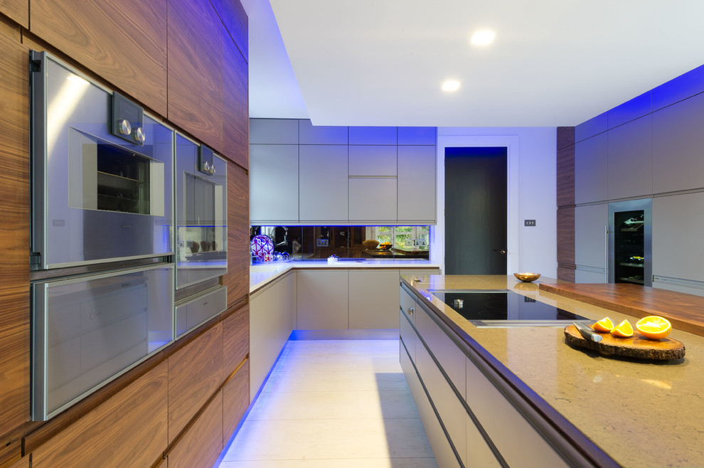 Inspiration for a large contemporary l-shaped eat-in kitchen in Other with an undermount sink, flat-panel cabinets, dark wood cabinets, solid surface benchtops, stainless steel appliances and with island.