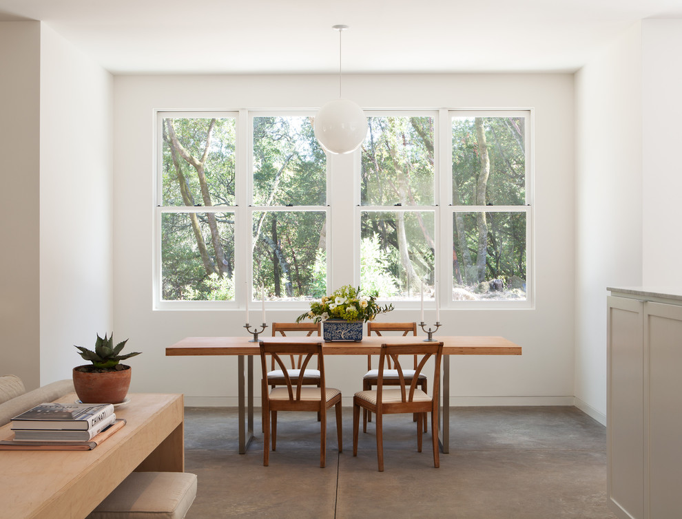 Inspiration for a transitional dining room in San Francisco with concrete floors.