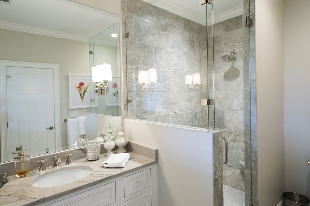 Inspiration for a small transitional 3/4 bathroom in Atlanta with shaker cabinets, white cabinets, a corner shower, a one-piece toilet, gray tile, ceramic tile, beige walls, an undermount sink and engineered quartz benchtops.