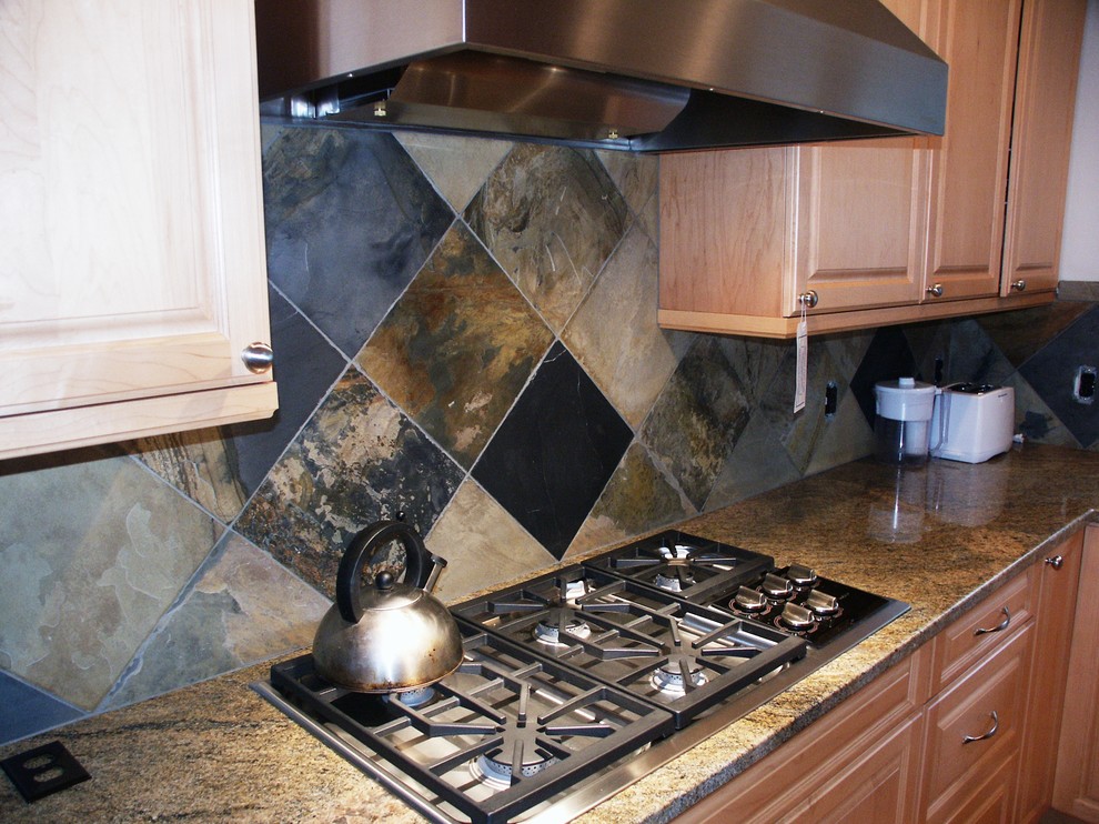 Kitchen - transitional kitchen idea in Seattle with raised-panel cabinets, granite countertops and stone tile backsplash