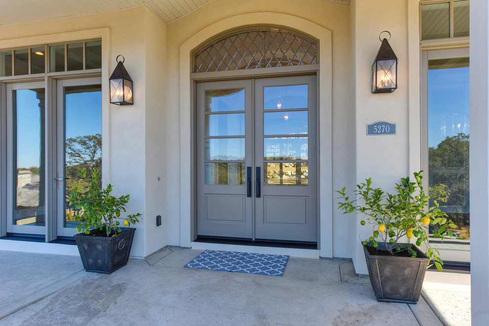 This is an example of a large transitional front door in Sacramento with grey walls, a double front door and a gray front door.