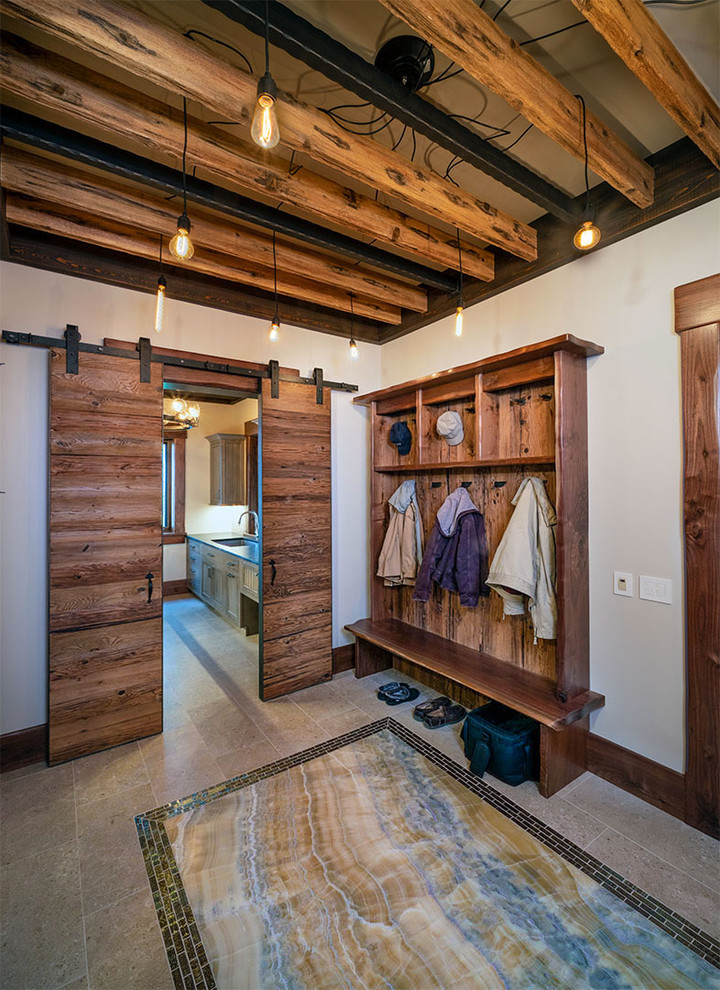 This is an example of an industrial mudroom in Other with granite floors.