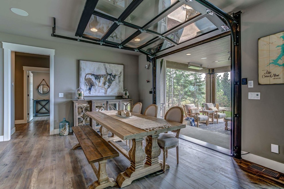 This is an example of a mid-sized country open plan dining in Seattle with grey walls, laminate floors and grey floor.