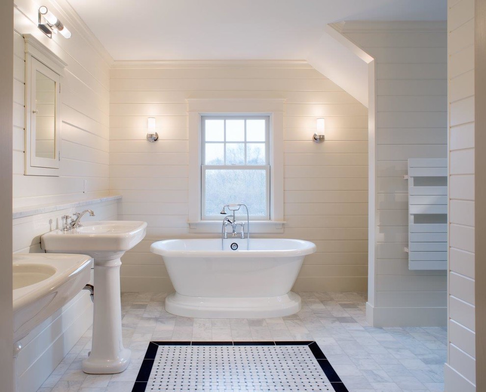 Photo of a mid-sized country master bathroom in Providence with a freestanding tub, a pedestal sink, white walls, marble floors and white floor.