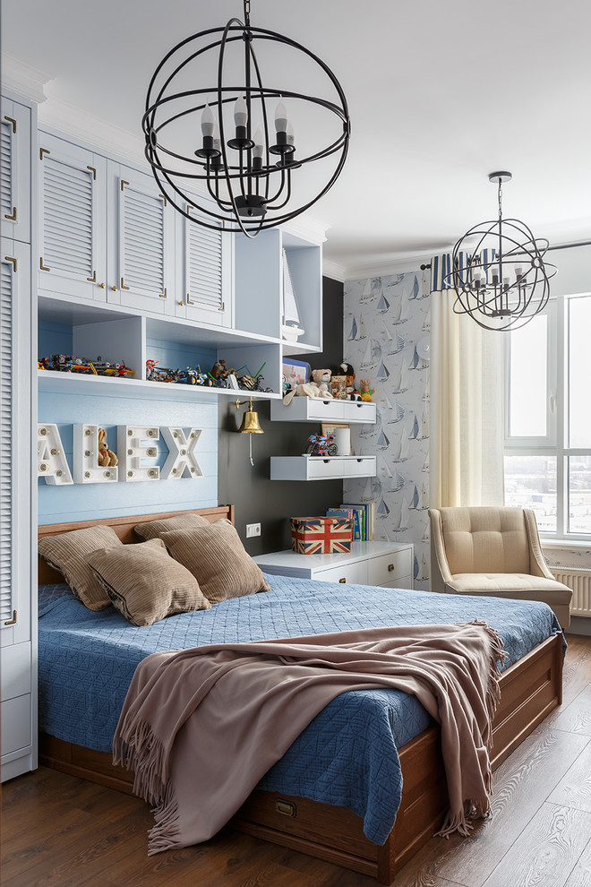 This is an example of a beach style kids' bedroom for boys with blue walls, dark hardwood floors and brown floor.