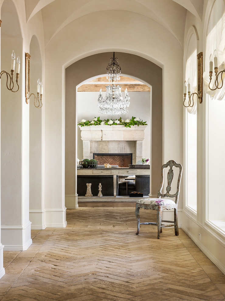 Inspiration for a large mediterranean hallway in Houston with beige walls, limestone floors and multi-coloured floor.