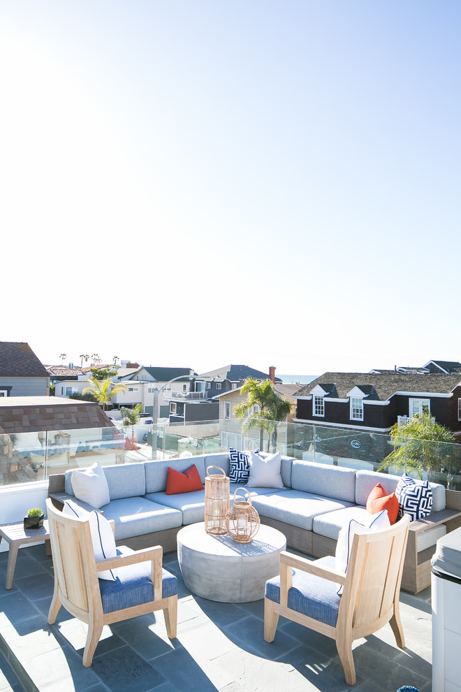 Beach style rooftop and rooftop deck in Orange County with no cover.