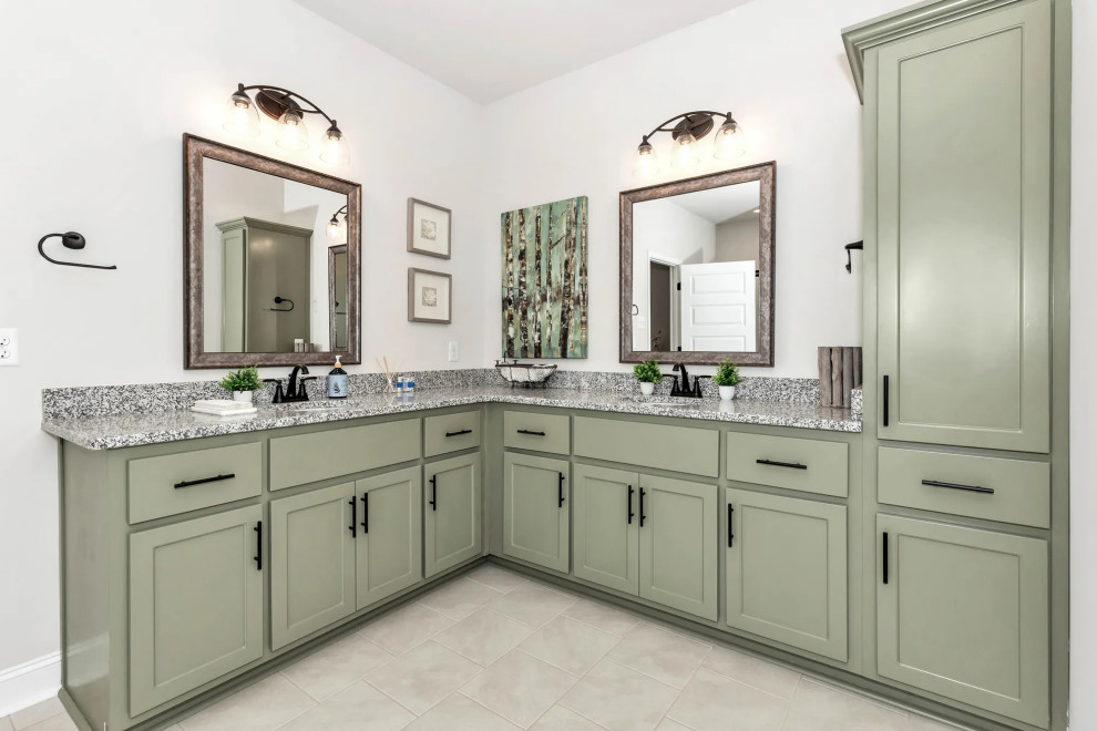 Medium sized classic ensuite bathroom with green cabinets, an alcove bath, an alcove shower, grey walls, a submerged sink, granite worktops, beige floors, a hinged door, grey worktops, an enclosed toilet, double sinks and a built in vanity unit.