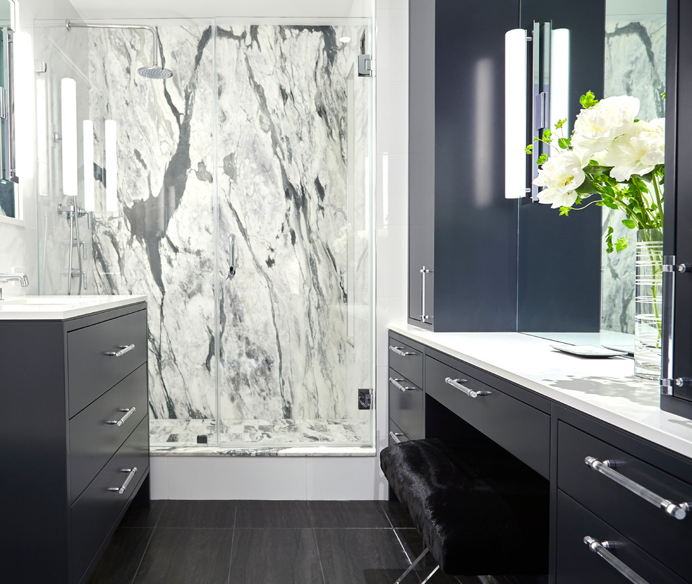 This is an example of a small contemporary master bathroom in New York with flat-panel cabinets, black cabinets, an alcove shower, black tile, gray tile, white tile, an alcove tub, a one-piece toilet, stone slab, porcelain floors, an undermount sink, solid surface benchtops, black floor and a hinged shower door.