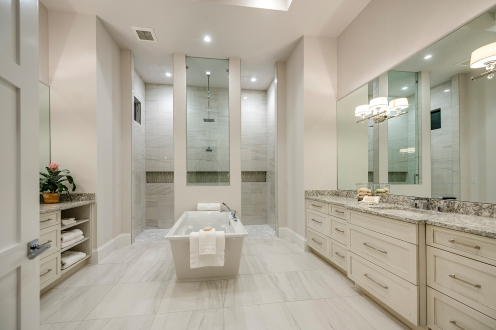 Photo of a large beach style master bathroom in Other with a freestanding tub, beige walls, ceramic floors, an undermount sink, beige floor, an open shower, a double vanity, coffered and an alcove shower.