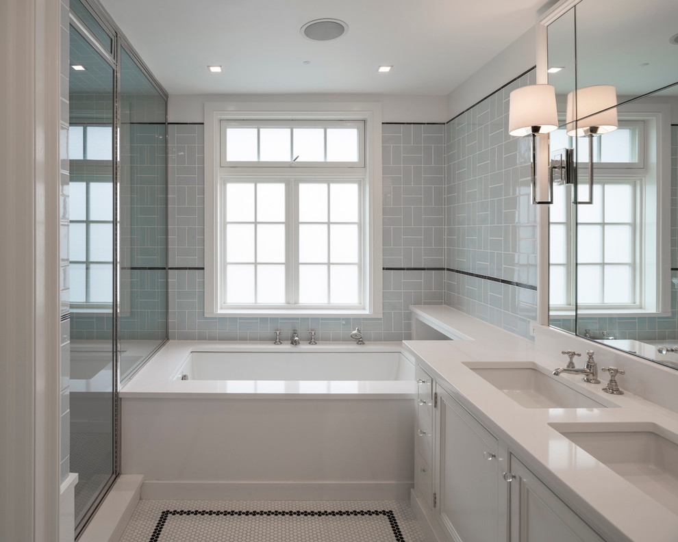 Inspiration for a transitional bathroom in New York with an undermount sink, an undermount tub, a corner shower, white tile, subway tile, blue walls and mosaic tile floors.