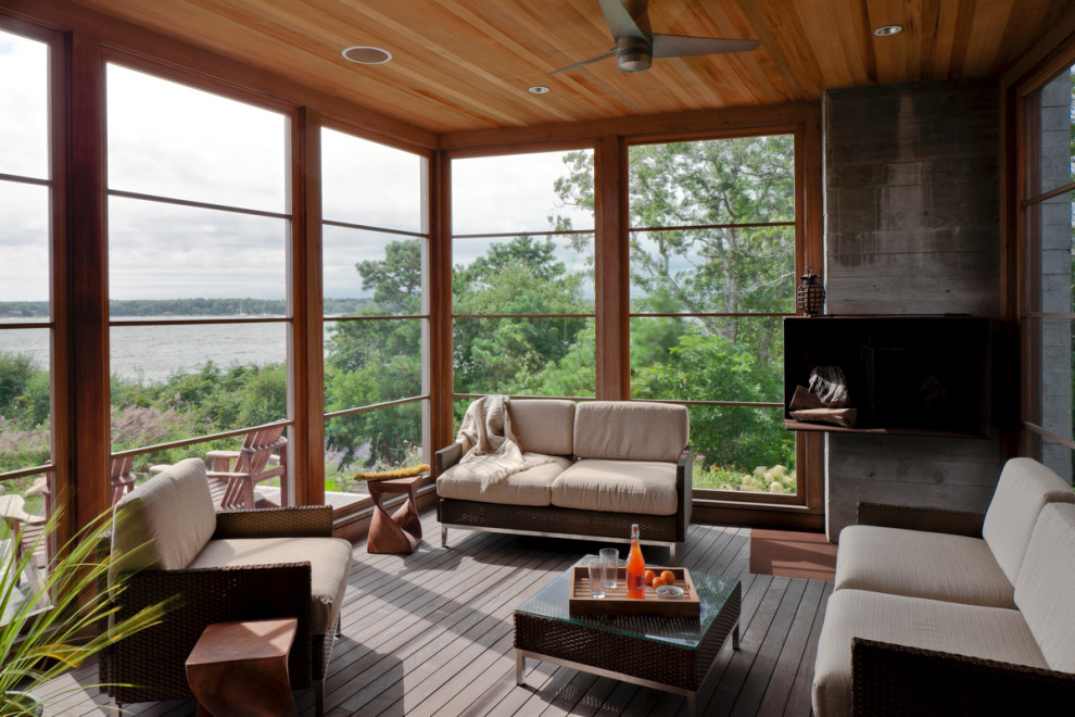 Inspiration for a beach style sunroom in Boston with dark hardwood floors, a standard ceiling and brown floor.
