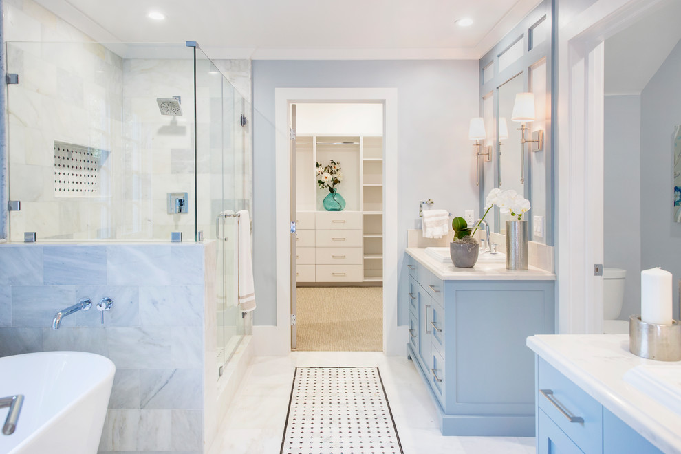 Inspiration for a transitional master bathroom in Los Angeles with shaker cabinets, blue cabinets, a corner shower, white tile, blue walls, a drop-in sink, multi-coloured floor and a hinged shower door.