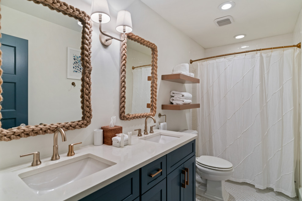 Mid-sized beach style bathroom in Other with white walls, shaker cabinets, blue cabinets, an alcove tub, a shower/bathtub combo, mosaic tile floors, an undermount sink, white floor, a shower curtain, white benchtops, a double vanity and a built-in vanity.