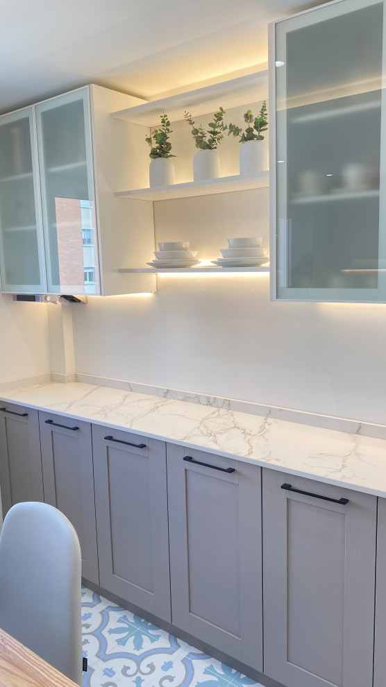 Example of a large transitional u-shaped porcelain tile and multicolored floor enclosed kitchen design in Other with an undermount sink, beaded inset cabinets, pink cabinets, marble countertops, white backsplash, marble backsplash, colored appliances, two islands and white countertops