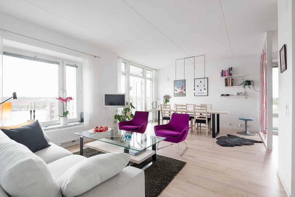 Design ideas for a mid-sized scandinavian open concept living room in Gothenburg with white walls, light hardwood floors, beige floor and no fireplace.