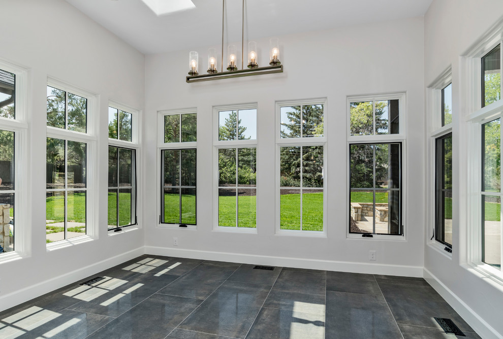 Photo of a mid-sized country sunroom in Denver with slate floors, a standard ceiling and grey floor.