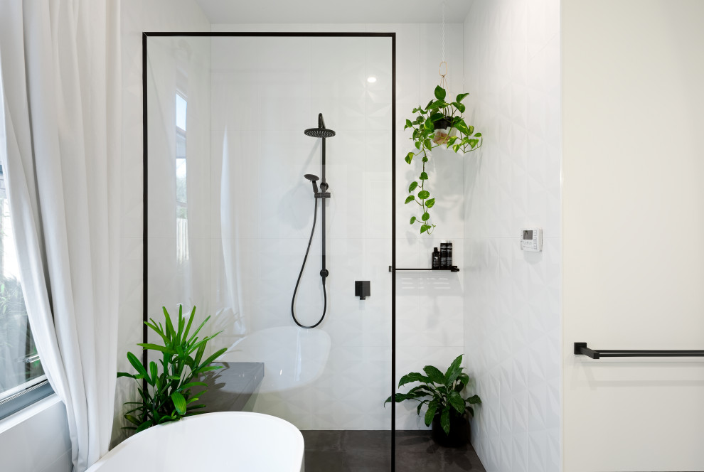 Design ideas for a mid-sized contemporary bathroom in Melbourne with a freestanding tub, ceramic floors, an open shower, a curbless shower, white tile, white walls and grey floor.