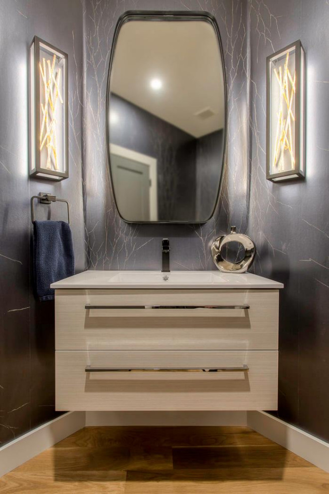Design ideas for a small transitional powder room in Denver with flat-panel cabinets, beige cabinets, black tile, black walls, light hardwood floors, an undermount sink, engineered quartz benchtops, brown floor, white benchtops, a floating vanity and wallpaper.