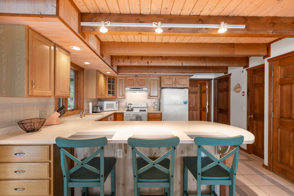 Design ideas for a beach style kitchen in Portland Maine with exposed beam.