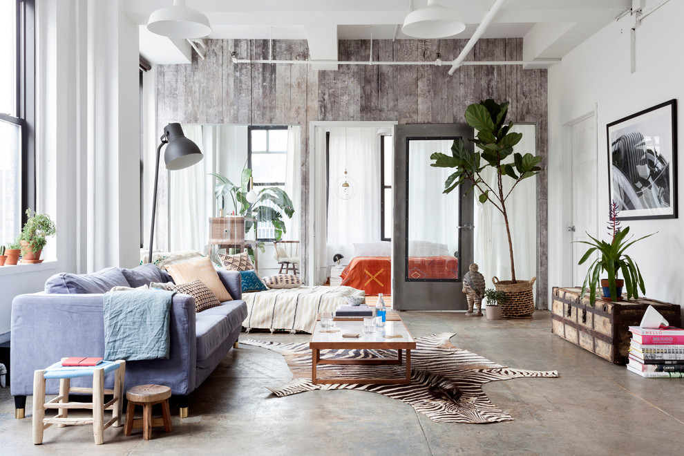 Industrial living room in New York with white walls and ceramic floors.