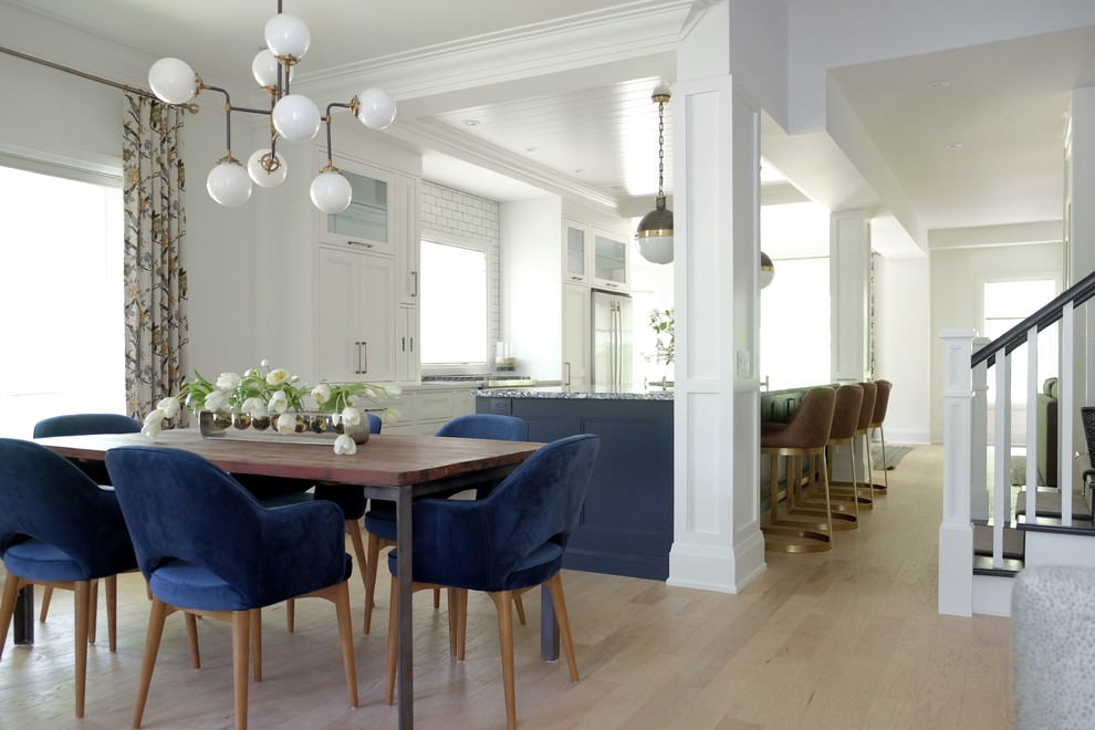 Inspiration for a transitional light wood floor and beige floor kitchen/dining room combo remodel in Toronto with white walls