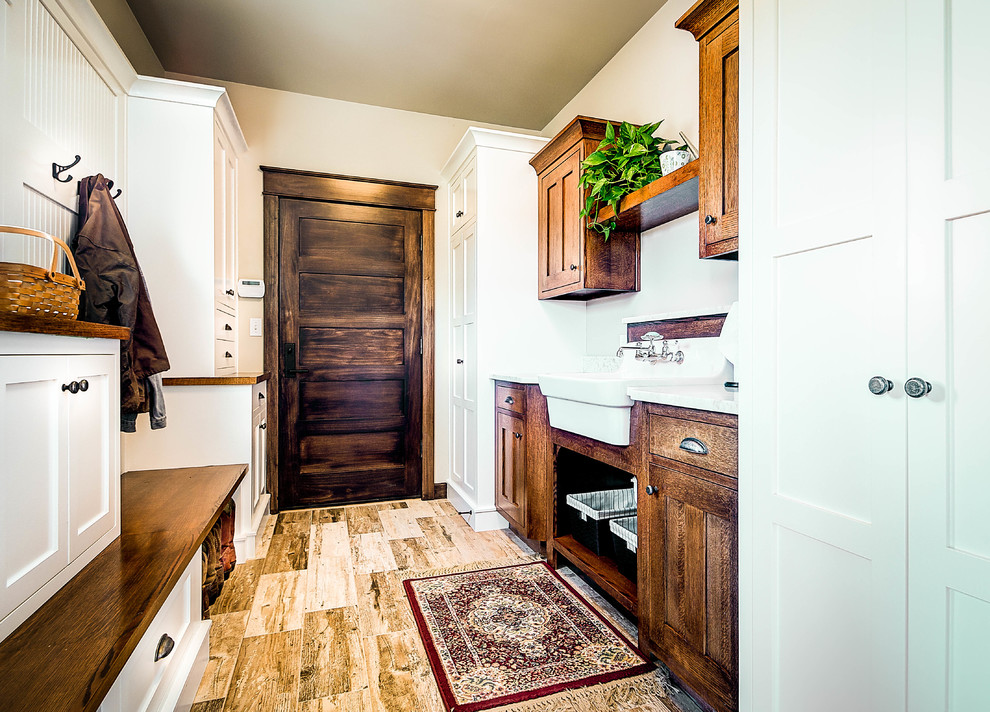 Mid-sized country mudroom in Other with beige walls, porcelain floors, a single front door and a dark wood front door.