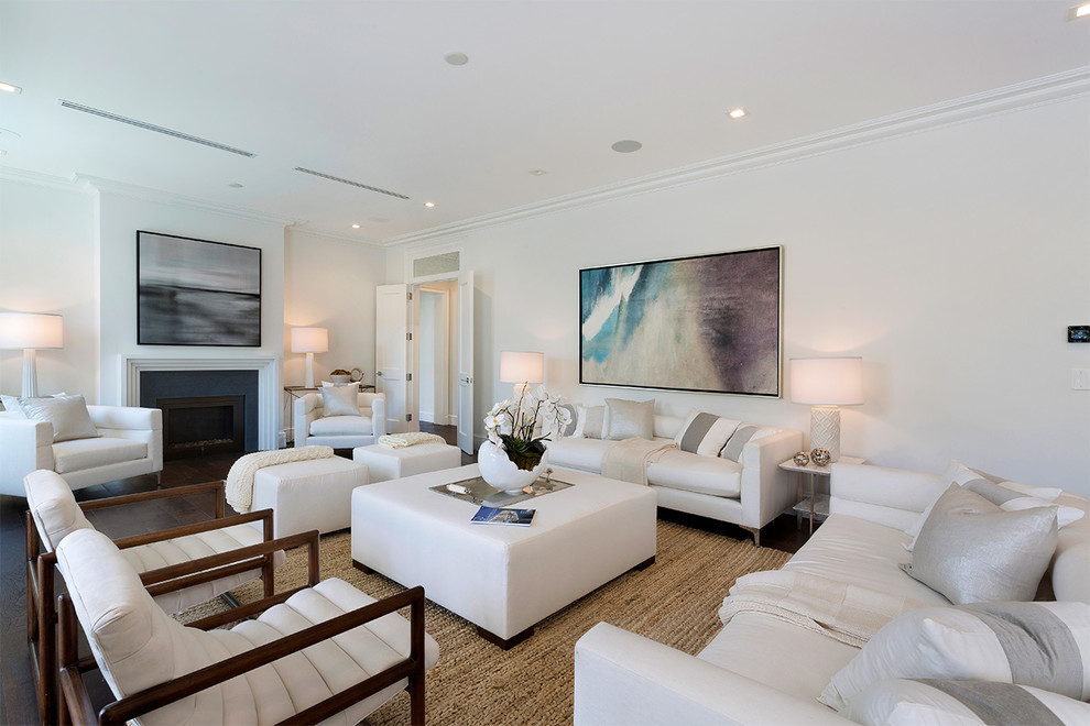 Inspiration for a mid-sized transitional formal open concept living room in Miami with white walls, dark hardwood floors, a standard fireplace, a plaster fireplace surround, no tv and brown floor.