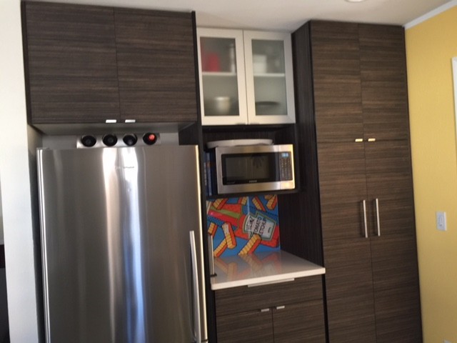 Inspiration for a mid-sized contemporary u-shaped ceramic tile and white floor eat-in kitchen remodel in Denver with an undermount sink, flat-panel cabinets, white cabinets, solid surface countertops, stainless steel appliances and a peninsula