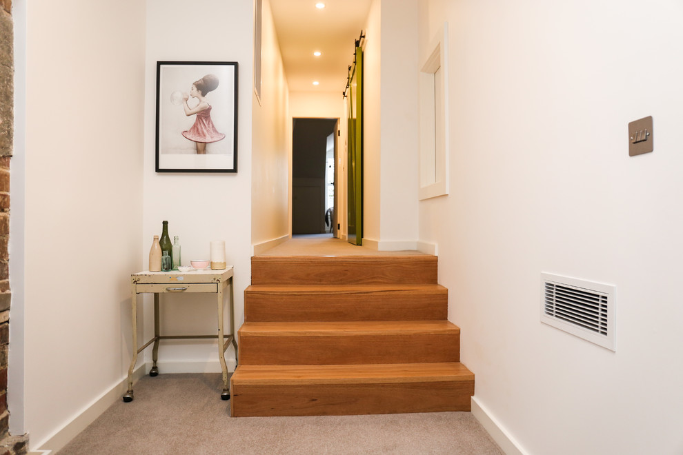 Design ideas for a small contemporary wood u-shaped staircase in Sydney with wood risers.