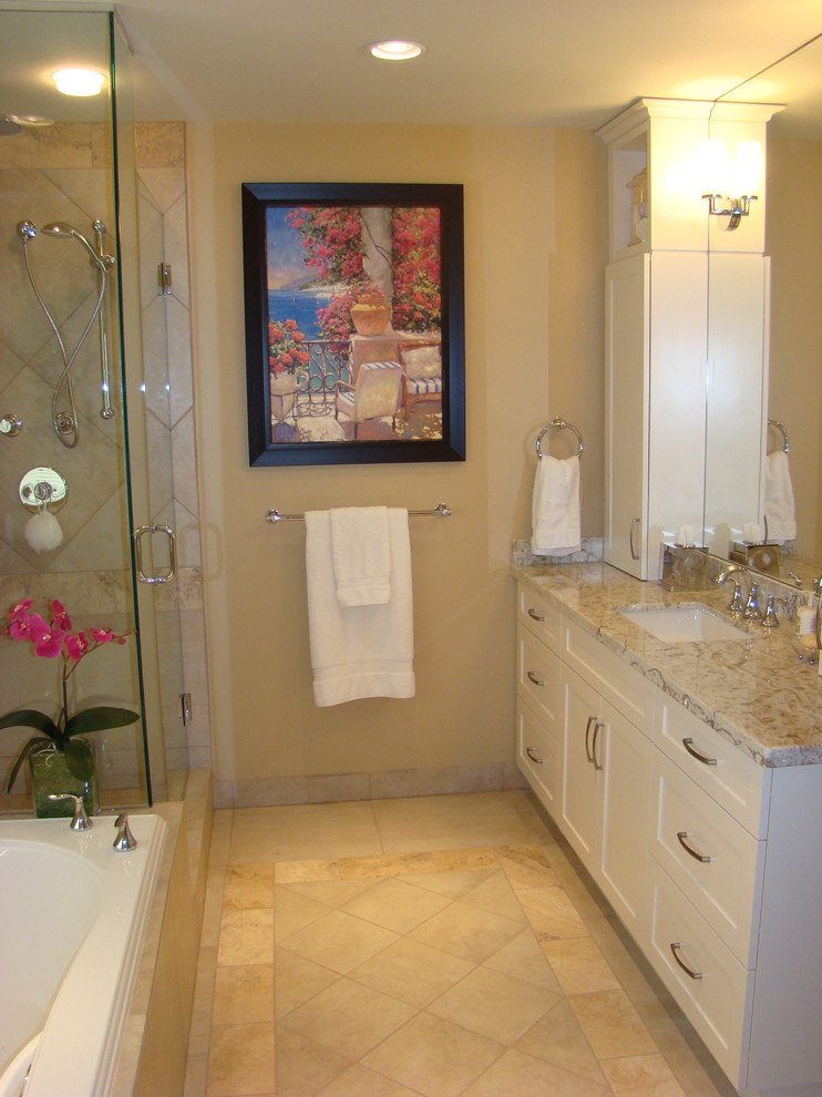 This is an example of a mid-sized transitional master bathroom in Vancouver with an undermount sink, shaker cabinets, white cabinets, granite benchtops, a drop-in tub, a corner shower, beige tile, porcelain tile, beige walls and porcelain floors.