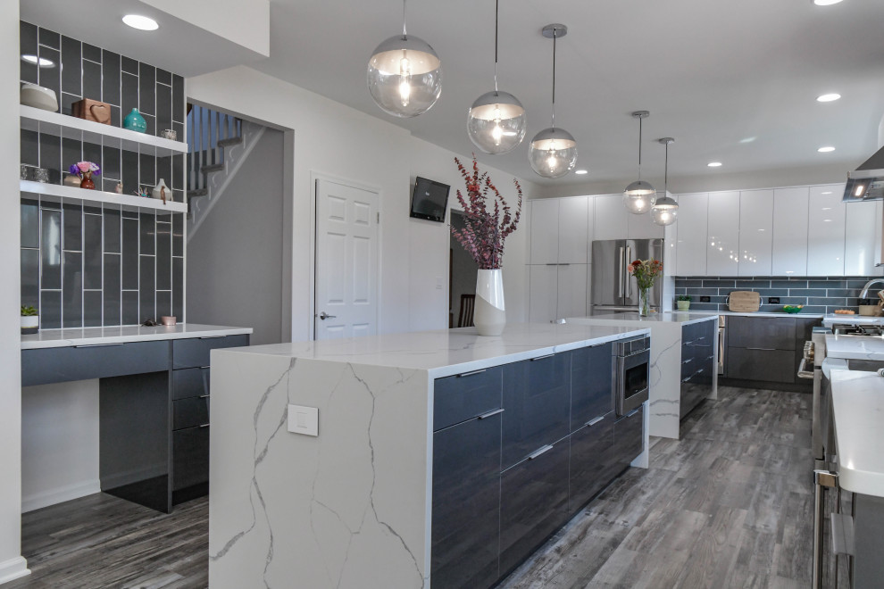 Eat-in kitchen - large contemporary l-shaped vinyl floor and gray floor eat-in kitchen idea in Philadelphia with a farmhouse sink, flat-panel cabinets, gray cabinets, quartz countertops, gray backsplash, porcelain backsplash, stainless steel appliances, two islands and white countertops