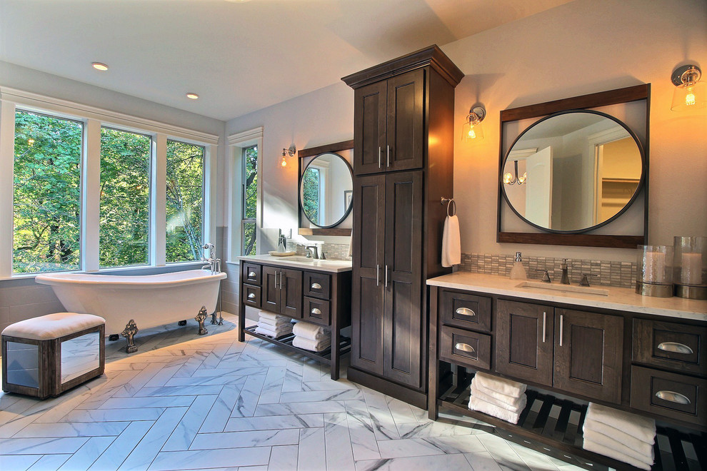 Photo of an expansive arts and crafts master wet room bathroom in Portland with recessed-panel cabinets, dark wood cabinets, a freestanding tub, a two-piece toilet, multi-coloured tile, ceramic tile, white walls, ceramic floors, an undermount sink, engineered quartz benchtops, multi-coloured floor and a hinged shower door.